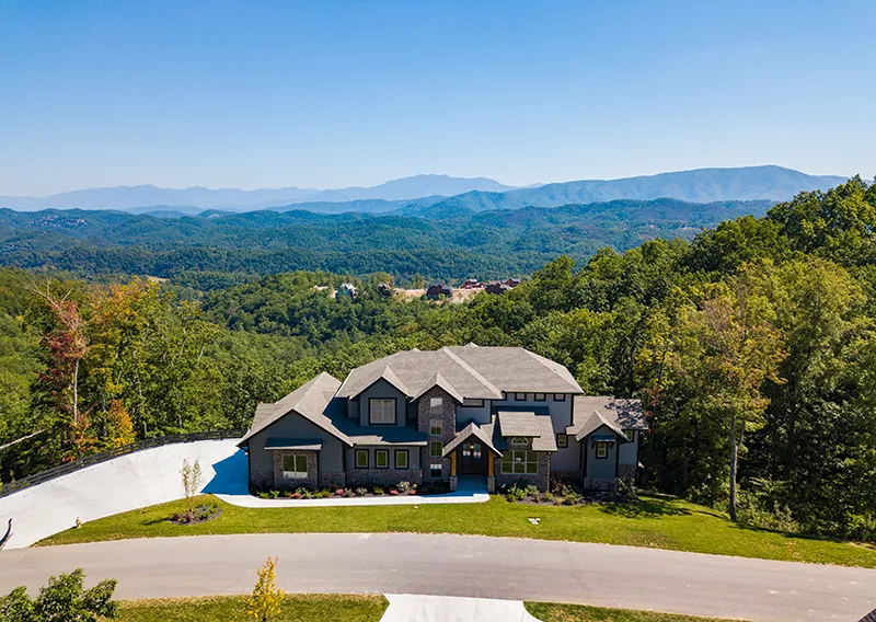 an aerial view of a home in the mountains